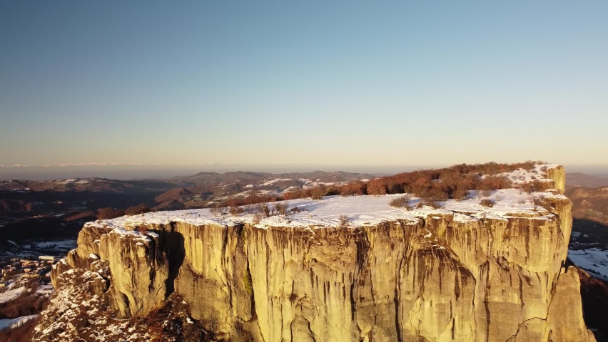 Huge flat rock on italian appennini mountains with snow