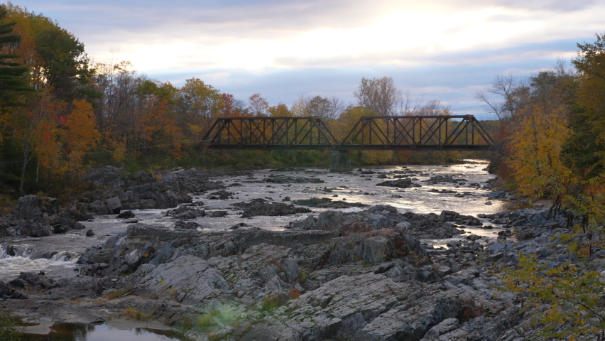A high resolution stabilized video of an old rusty railway bridge spanning over the Carrabassett River in New Portland Maine.