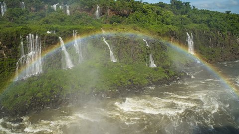 Famous Iguazu falls, real nature wonder. Panoramic view on several falls with rainbow over the river