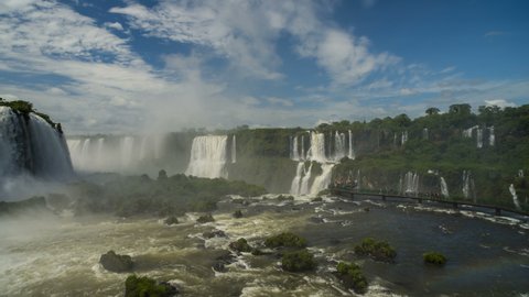 Iguazu falls panorama with many tourists on the observation deck