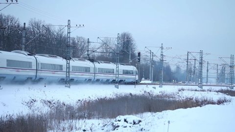 Passenger Train Passing by raising clouds of white snow with original sound