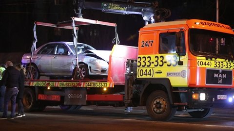 Kyiv, Ukraine - 03.13.2021: evacuator loads Subaru Impreza at night