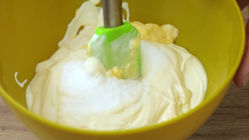 Mixing mayonnaise and sour cream for making Russian traditional salad Olivier, the concept of making a salad, food from the restaurant | Shutterstock HD Video #1069057060
