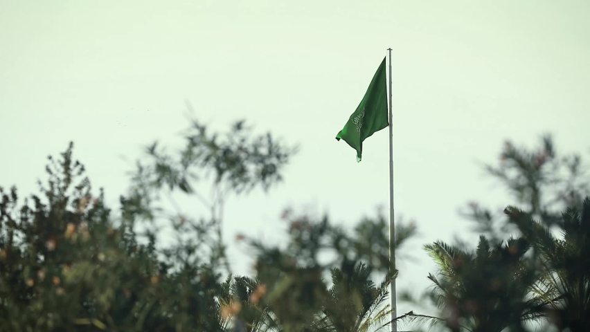 SAUDI ARABIA FLAG BEHIND THE TREES Royalty-Free Stock Footage #1069057132