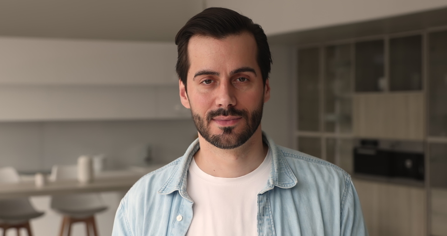 Head shot confident handsome 30s man pose at home in living room alone smile look at camera. Professional occupation person, satisfied client of services, blogger and freelancer male portrait concept Royalty-Free Stock Footage #1069058662