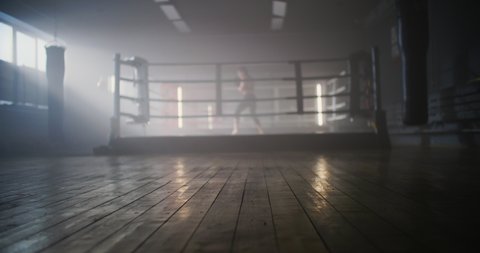 Caucasian Woman Athlete Doing a Shadow Fight in Boxing Ring, Training, Preparing for a Tournament - Fitness, Sports Concept. Female Trains Punches Looking Directly