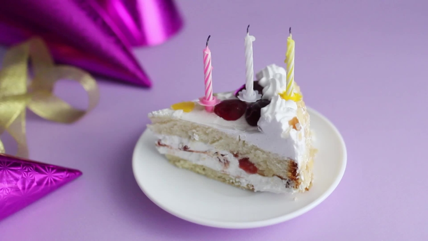 three candles in a piece of cake, birthday cake