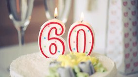 Birthday candle as number sixty 60 on top of sweet cake on the table, 60th birthday, toned video	 - Powered by Shutterstock - Get 15% off with code: PIKWIZARD15