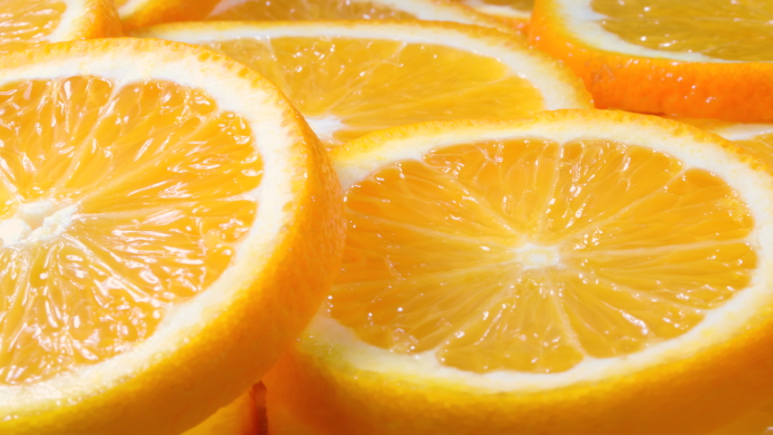 Macro shot of fresh juicy orange fruit slices. Close-up fruit texture. Royalty-Free Stock Footage #1069070497