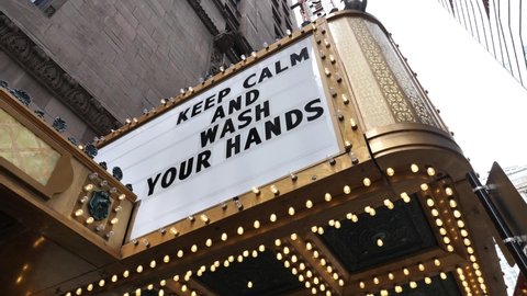 Covid-19 Lockdown in Chicago USA, Keep Calm and Wash Your Hands Message Sign in Exterior of Theatre, Low Angle View