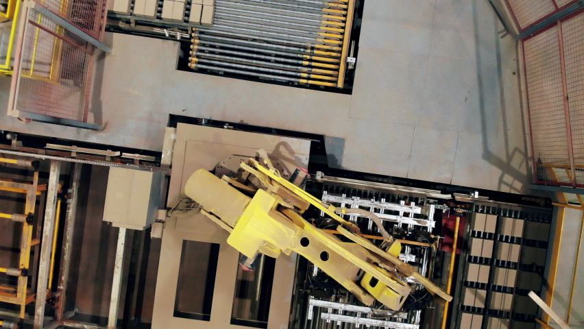 Top view of a robotic arm relocating bricks from the conveyor Royalty-Free Stock Footage #1069077844