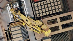 Top view of a robotic arm relocating bricks from the conveyor - Powered by Shutterstock - Get 15% off with code: PIKWIZARD15