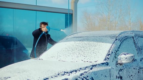 Dirty Car Cleaning And Protection With Active Foam.Clean Water Spray Pressure.Man Washing Car On Wash Self-Service.Washes Automobile Active Foam And Osmosis Water.Before Detailing And Waxing Vehicle.