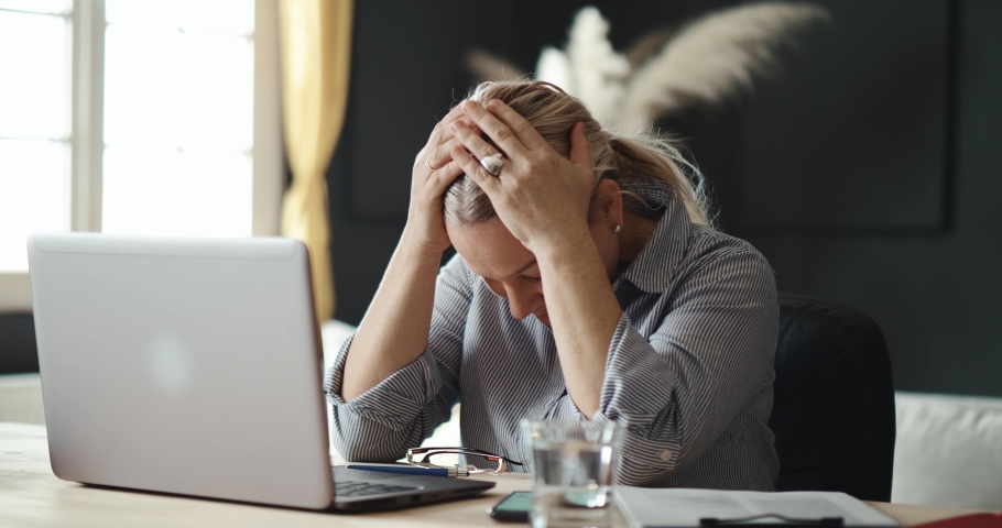 Mature disappointed woman gets upset about losing her job online. Nervous person worried about finances. An elderly woman under stress closes her laptop | Shutterstock HD Video #1069080226