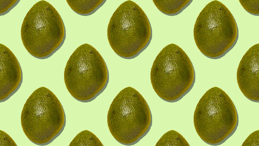 Stop motion animation Whole ripe avocados are replaced by half-pitched avocados diagonally on a green background Royalty-Free Stock Footage #1069082455