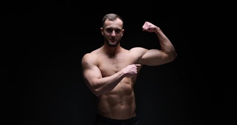 Man flexing biceps in studio
