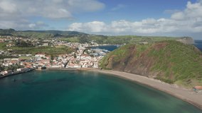 Horta, Faial Island, Azores. Aerial panoramic view of beautiful seaside town under the clear blue skies. Tranquil bay with townscape behind on a sunny day. High quality 4k footage.