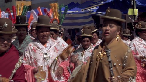 Quillacollo, Bolivia - August, 2020: Bolivian Cholitas (Andean Women) dancing in the Street during the Festival of the Virgin of Urkupiña. 4K Resolution. 