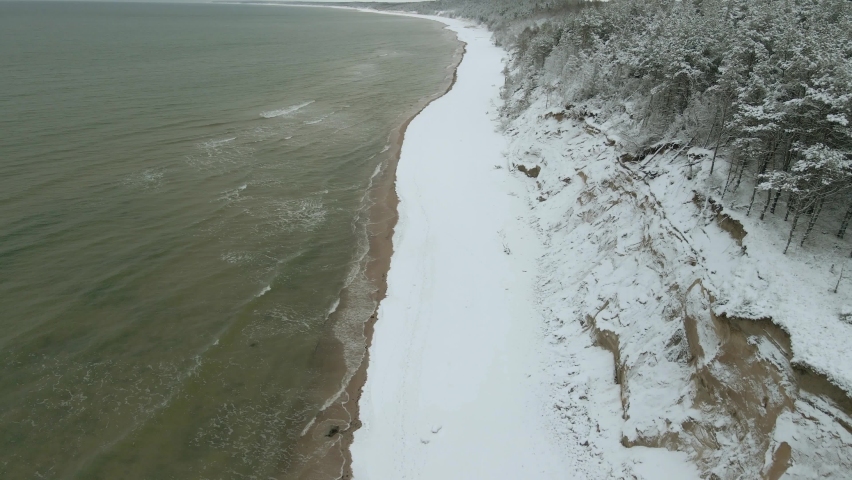 Snow covered beach, cloudy winter day by the Baltic Sea, Jurkalne Winter 2020
