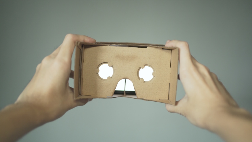 Wearing VR headset made of cardboard. First person point of view. Royalty-Free Stock Footage #1069091395