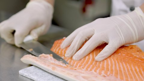 peeling fish fillets with a knife close-up