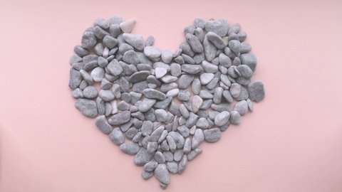 Woman hands creating heart from stones. SPA, manicure. Health concept. Close up.