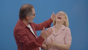 The old man saying naughty things to his beautiful wife's ear. Beautiful elderly couple laughing together a lot. Concept of having fun together. - Powered by Shutterstock - Get 15% off with code: PIKWIZARD15