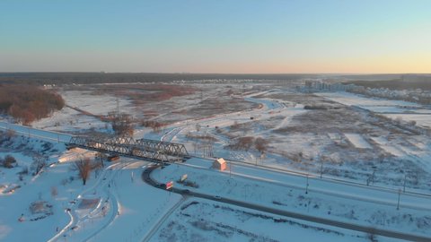 Railroad in the suburbs winter snow cars road aerial drone view left side flying around camera movement Irpin Ukraine