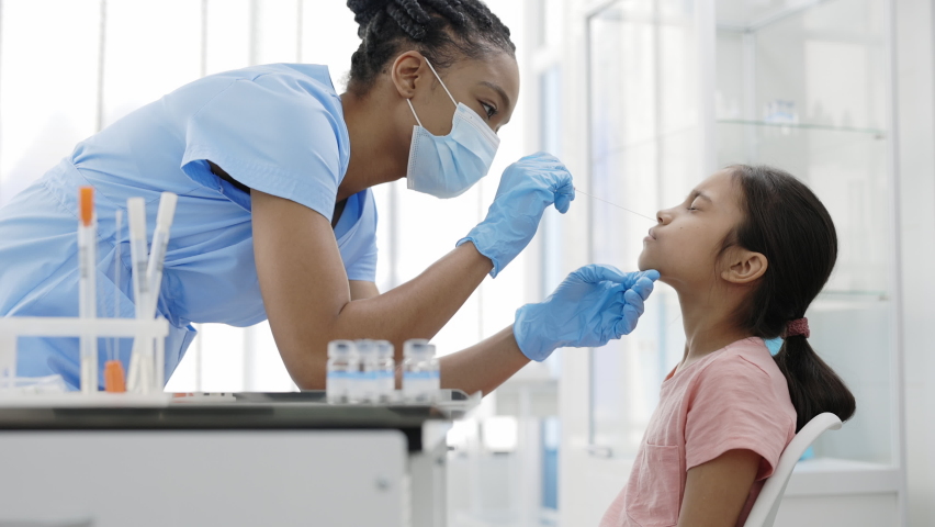 Crop view of medical female nurse in protectivemask and gloves taking swab from nose of little girl in hospital. Concept of PCR diagnostic method, rapid covid test. | Shutterstock HD Video #1069112521