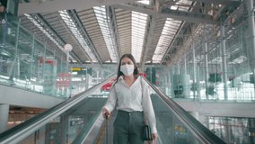 A business woman is wearing protective mask in International airport, travel under Covid-19 pandemic, safety travels, social distancing protocol, New normal travel concept - Powered by Shutterstock - Get 15% off with code: PIKWIZARD15