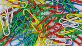 Stop motion animation. Multicolor paper clips animated background. Office concept