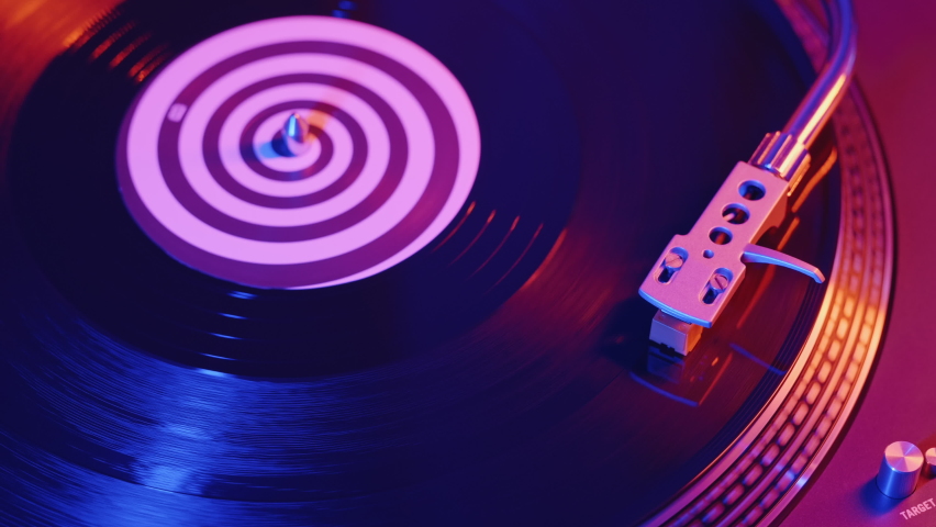 Vinyl Retro Records Player turntable RGB Led of red and blue neon lights. Needle slides smoothly on rotate  black vinyl record. Closeup background. Rotating plate Top view. Disco Styles 70s, 80s, 90s Royalty-Free Stock Footage #1069120438