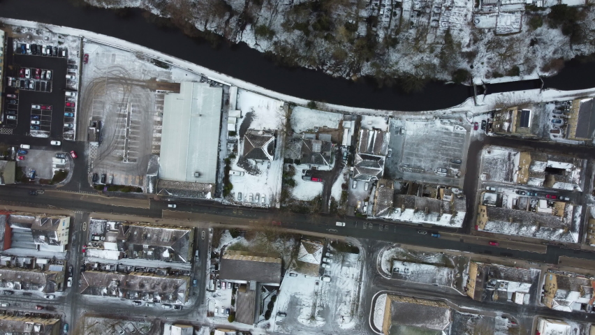 Short spin shot from a drone of a snowy street and canal in West Yorkshire. | Shutterstock HD Video #1069125391