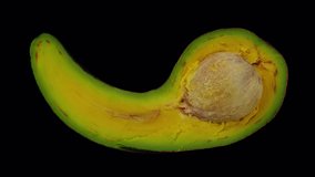 Realistic render of a rolling half Long Neck (Russell) Avocado with the pit on transparent background (with alpha channel). The video is seamlessly looping, and the 3D object is scanned from a real Av