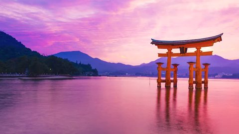 Sunset time-lapse of the famous orange shinto gate (Torii) of Miyajima island of Hiroshima prefecture, Japan.