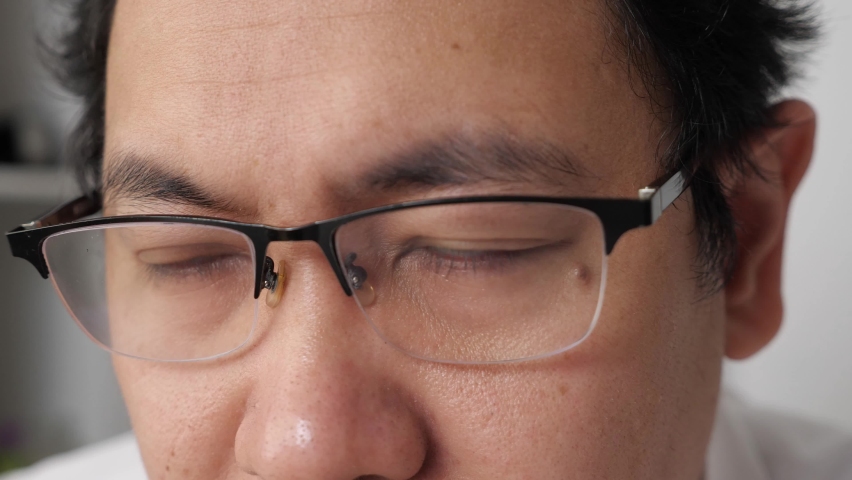 Close up of a man wearing glasses checking his eye sight, blur vision problem concept Royalty-Free Stock Footage #1069130662