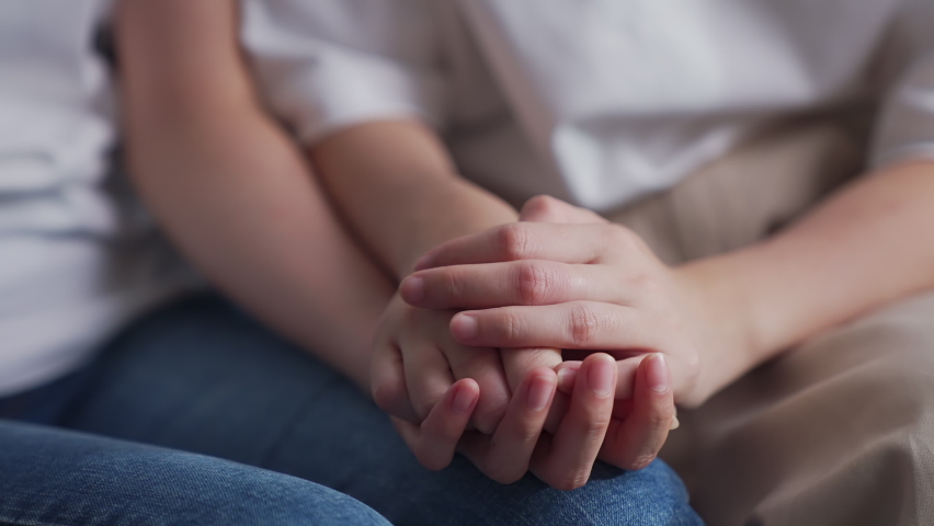  Close-up shot of two people holding hands for encouragement. | Shutterstock HD Video #1069132489