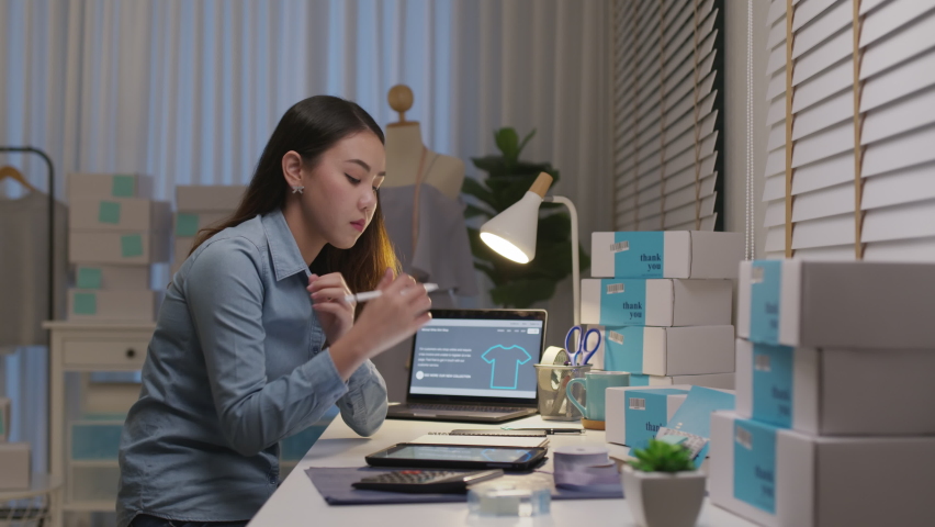 Young attractive asia female business owner thoughtful serious doubtful feel stress worry with financial problem in SME crisis small business challenges impact from covid coronavirus at home office. Royalty-Free Stock Footage #1069139653