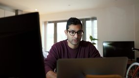 Mixed race business man working from home engaging in video call using laptop