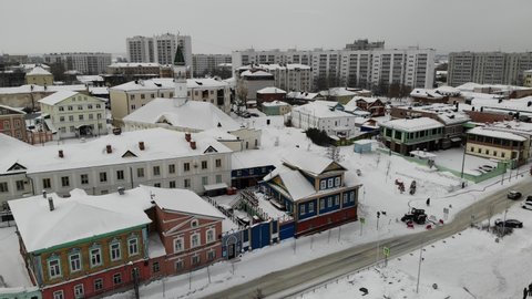 The Old-Tatar Quarter Sloboda settlement in Kazan. Old wooden houses with mosque Tatarstan. Winter snow. Aerial view. Flying over. Drone is moving left and back