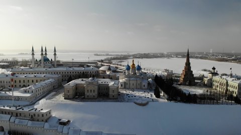 Aerial Kazan city center Kremlin at winter sunny day. Ortodox church and mosque. Traffic. Near Volga river. Aerial view. Flying over. Drone is moving left. High quality 4k footage