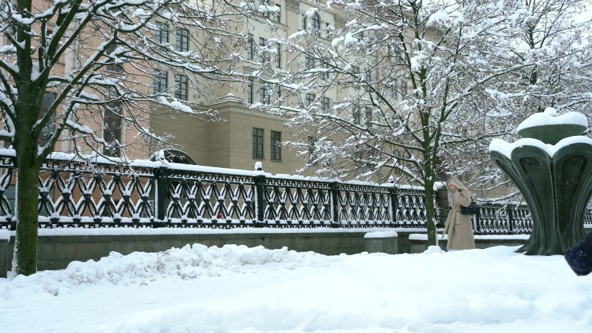 Beautiful blonde alone walks in the winter park