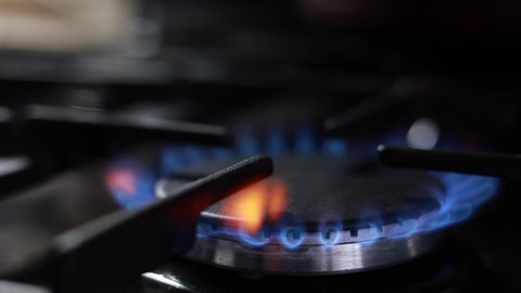 A Burning Flame A Gas Stove In The Kitchen Background. Panning Dolly Slider Shot.