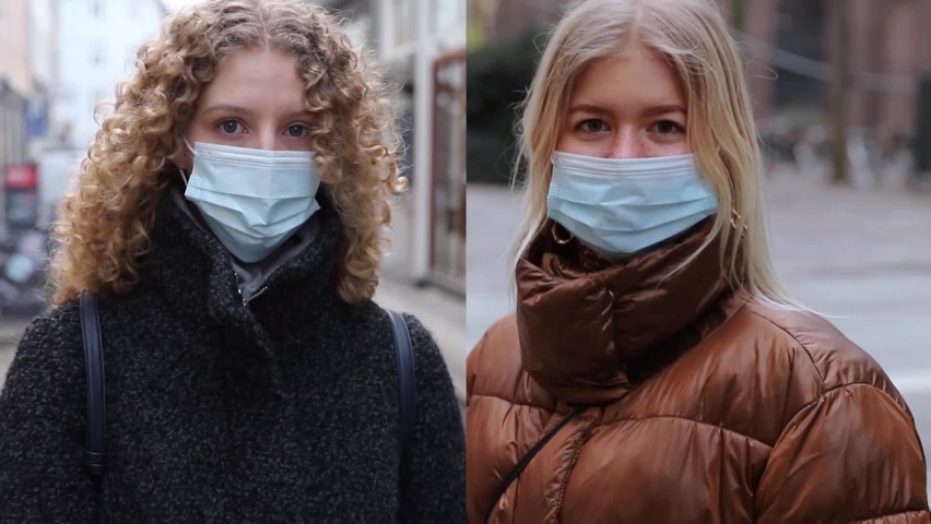 Portrait of 2 girls who wear a surgical mask outdoor to protect themself from the coronavirus pandemic.