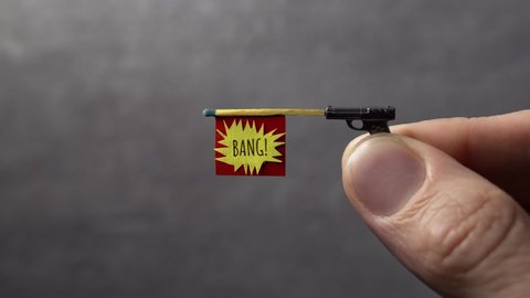 Small toy gun with bang flag shooting out of it