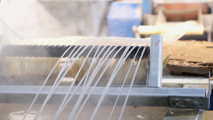 Plastic strands go to strand cutter to recycle plastic and create pellets from pellet mill after hydrocooling with water, industrial concept, recyclable, and pellets for recycling plastic | Shutterstock HD Video #1069174999