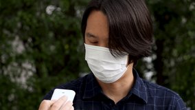 4K Video Asian man with face mask show bad result of PM2.5 air detector  in hand with red alert light. Concept for Air pollution and environment crisis.