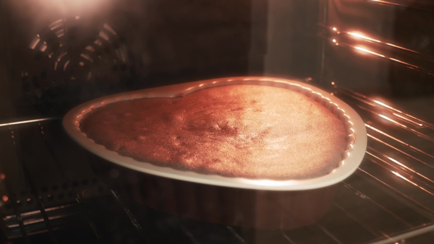 Timelapse of baking cake in oven. Tasty pie in oven. Homemade pie baked. Delicious cake biscuit is rising up in oven. Process of making sweet pastry | Shutterstock HD Video #1069181263