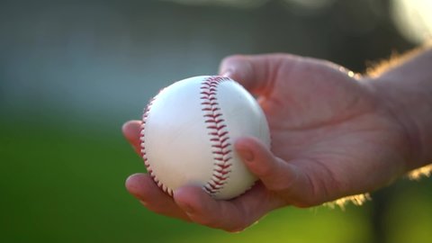 Baseball Pitcher Flicks Ball Up In Air In Preparation To Throw