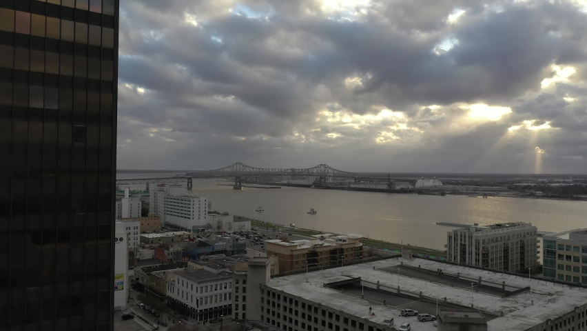 Downtown Baton Rouge Louisiana City Skyline Building in Foreground with Mississippi River Bridge and Sun through the Clouds Slow Push In Drone Shot Mavic 2 Pro